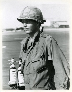 AP NEWS PHOTO: SOLDIER CARRIES NUOC-MAM (FISH SAUCE)